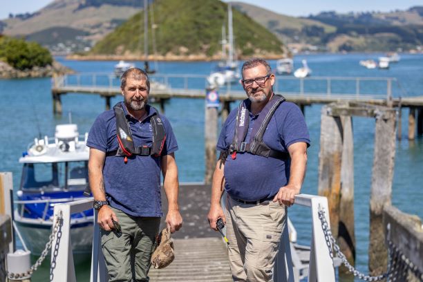 Deputy Harbourmaster Pete Dryden (left) and Harbourmaster Steve Rushbrook with the harbourmaster’s vessel, Kaitiaki.