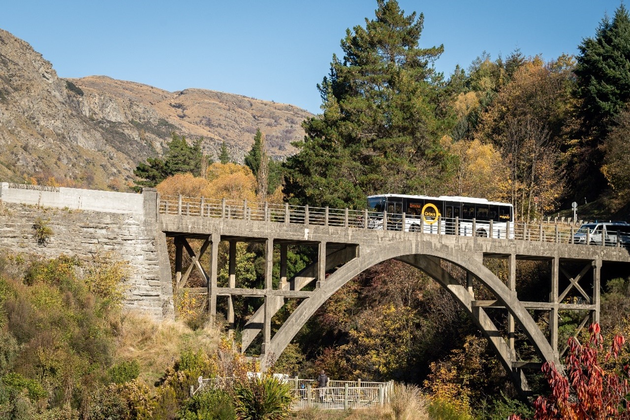 Orbus bus crossing the Edith Cavell Bridge over the Shotover River at Arthur’s Point