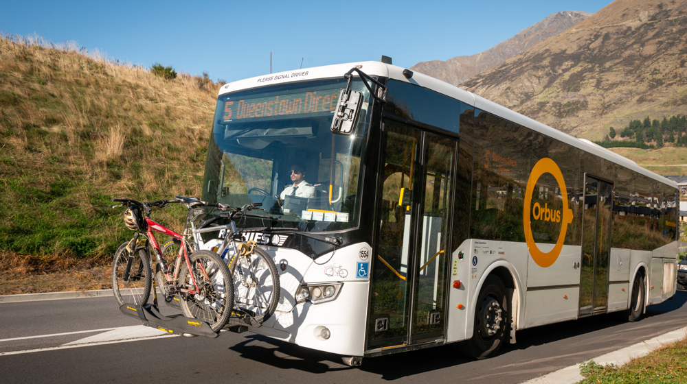 Bikes loaded on the front rack of an Orbus Bus in Queenstown