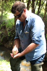 ORC scientist Pete Ravenscroft with the banded kokopu he found in Smiths Creek