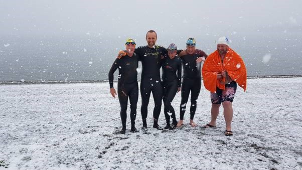 Photo: Wanaka Lake Swimmers about to take to the water for a chilly swim during a recent spring snow fall in September.