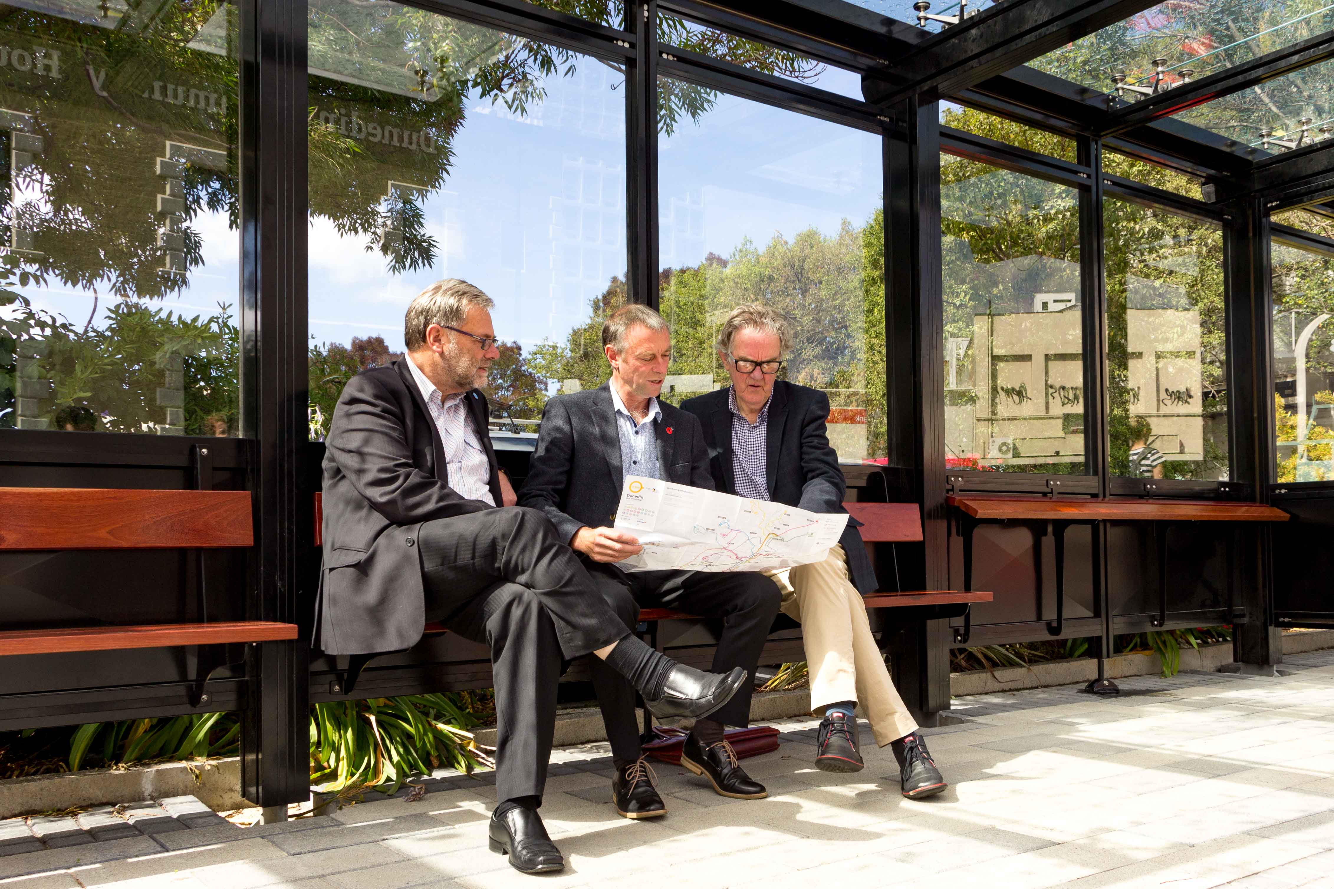 Cr Trevor Kempton, Chairman Stephen Woodhead, and Cr Michael Deaker perusing the new map and timetable at the Bus Hub.