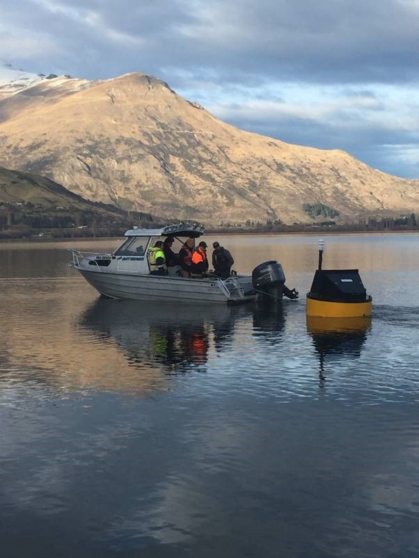 The monitoring buoy being towed across Lake Hayes towards its moorings today.