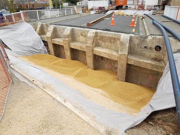 piles of sand backfilling a bridge culvert