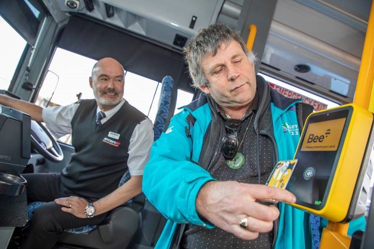 Dunedin Orbus passenger David King uses the new Bee Card watched on by Ritchies driver Peter Craik.