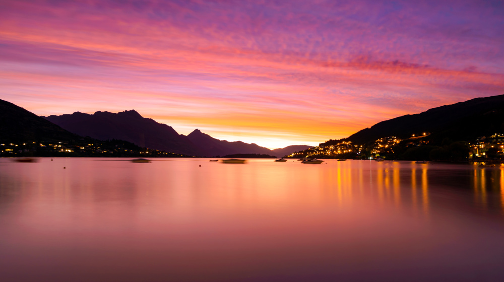 Vibrant Sunset Paints The Sky Over Tranquil Lake Adobestock 1757361017