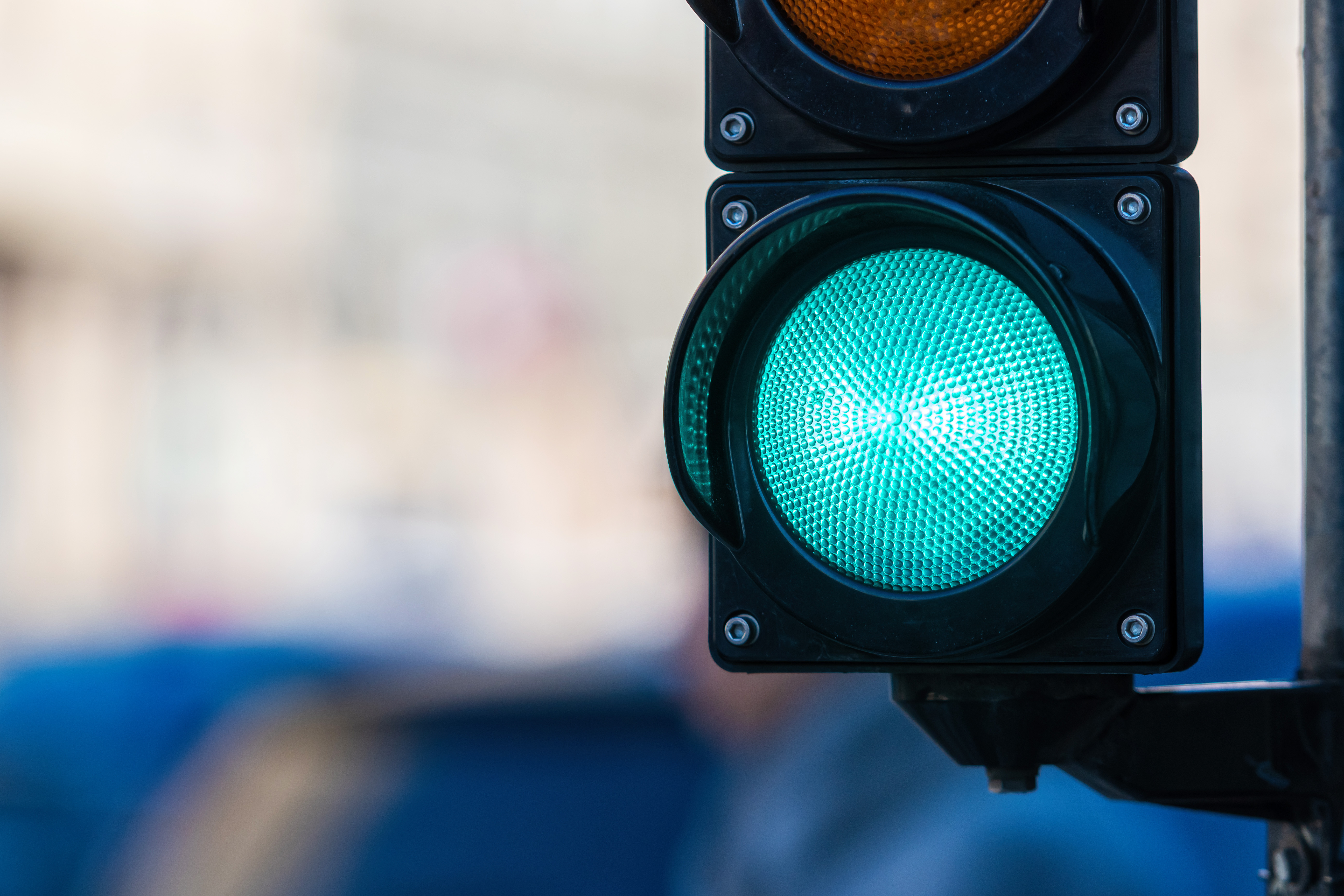 Close Up Of Traffic Semaphore With Green Light On Defocused City Street Background Adobestock 436253388