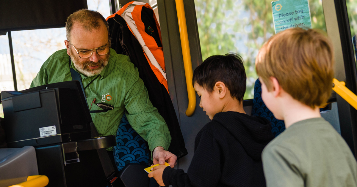 Children using Bee card to get on bus with driver helping Orbus Fare Concessions For Children And Youth