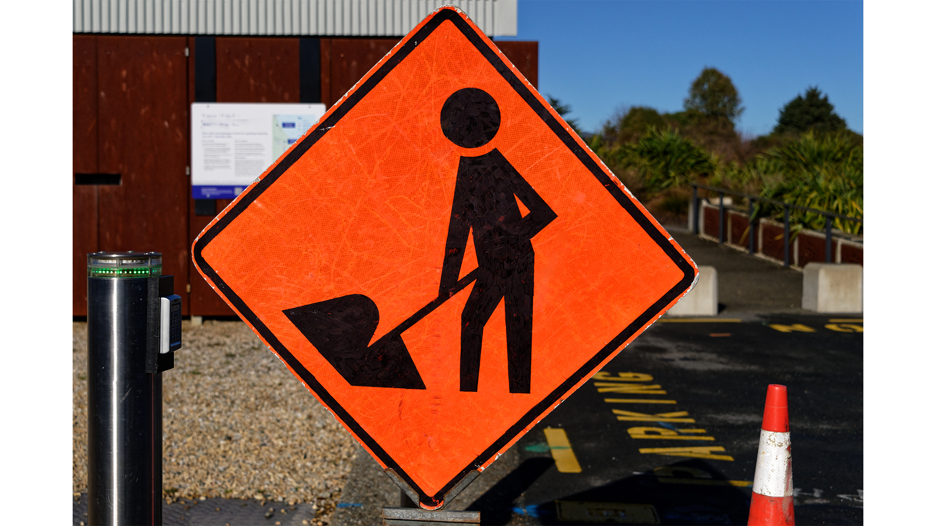A Man At Work Sign Is Positioned To Warn People Of Possible Danger Adobestock 286666136 1920X1080