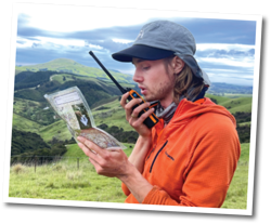 Jamie radioing the volunteer field team to coordinate workplans